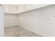 Large walk-in closet with wood floors, shelving, and a window at 300 N Gila Springs Blvd # 181, Chandler, AZ 85226