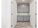 Hallway with gray cabinets, plank floors, and neutral paint, perfect for extra storage space at 300 N Gila Springs Blvd # 181, Chandler, AZ 85226