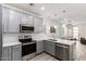 Bright kitchen with gray cabinetry, stainless steel appliances, and granite countertops at 300 N Gila Springs Blvd # 181, Chandler, AZ 85226