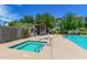 Community pool area with spa, sun loungers, and outdoor kitchen at 300 N Gila Springs Blvd # 181, Chandler, AZ 85226
