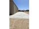 Long concrete area outside a metal storage building, with a vehicle in the distance at 30940 N Varnum Rd, San Tan Valley, AZ 85143