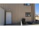 View of exterior door with windows, and rolled tires on the side of the metal building at 30940 N Varnum Rd, San Tan Valley, AZ 85143