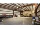 Spacious metal building interior with high ceilings, workbench, and ample storage at 30940 N Varnum Rd, San Tan Valley, AZ 85143