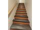 Stairway with wooden steps and handrail, providing access to different levels at 30940 N Varnum Rd, San Tan Valley, AZ 85143