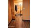 This walk-in closet has a hanging bar, space for storage and wood-look vinyl flooring at 30940 N Varnum Rd, San Tan Valley, AZ 85143