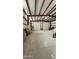 Large, empty warehouse space with multiple doors and a high ceiling with steel beams at 30940 N Varnum Rd, San Tan Valley, AZ 85143