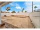 Spacious backyard with potential for customization, featuring a sturdy fence and mature palm trees at 3138 W Danbury Dr, Phoenix, AZ 85053