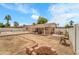 Wide backyard featuring a patio, pool, and firepit surrounded by an unfinished landscape at 3138 W Danbury Dr, Phoenix, AZ 85053