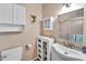 Charming bathroom with stylish vanity, mirror, built in storage and glass-enclosed shower at 3138 W Danbury Dr, Phoenix, AZ 85053