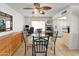 Bright dining area with ceiling fan, tile flooring, and a nearby workstation for added functionality at 3138 W Danbury Dr, Phoenix, AZ 85053