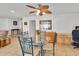 Cozy dining area with a glass table, ceiling fan, and easy access to the adjacent living spaces at 3138 W Danbury Dr, Phoenix, AZ 85053