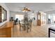 Bright dining area with ceiling fan, tile flooring, and convenient access to the kitchen and backyard at 3138 W Danbury Dr, Phoenix, AZ 85053