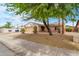 Single-story home with desert landscaping, mature shade trees, and a cozy front entrance at 3138 W Danbury Dr, Phoenix, AZ 85053