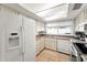 Spacious kitchen with white appliances, tile flooring, ample storage, and natural light at 3138 W Danbury Dr, Phoenix, AZ 85053