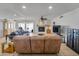 Bright living room with tile flooring, ceiling fan, fireplace, and sliding glass door to backyard at 3138 W Danbury Dr, Phoenix, AZ 85053
