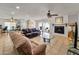 Spacious open concept living room with a fireplace, tile flooring, and access to the dining area at 3138 W Danbury Dr, Phoenix, AZ 85053