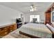 Comfortable main bedroom with built-in storage, desk space, and tile flooring at 3138 W Danbury Dr, Phoenix, AZ 85053