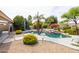 Lush backyard with a pool and stone pathways at 4020 W Menadota Dr, Glendale, AZ 85308