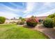 Well-manicured backyard featuring a lush lawn and vibrant landscaping at 4020 W Menadota Dr, Glendale, AZ 85308