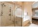Bright bathroom features a separate marble shower and tub, offering a spa-like experience at 4020 W Menadota Dr, Glendale, AZ 85308