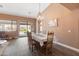 Cozy dining room features modern lighting, wood flooring, and views of the backyard oasis at 4020 W Menadota Dr, Glendale, AZ 85308