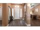 Inviting foyer features wood flooring, a large mirror, and views of an office space at 4020 W Menadota Dr, Glendale, AZ 85308