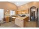 Well-equipped kitchen features stainless steel appliances, tile backsplash, and a functional center island at 4020 W Menadota Dr, Glendale, AZ 85308