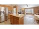 Modern kitchen with island, stainless steel appliances, and backyard view at 4020 W Menadota Dr, Glendale, AZ 85308