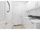 Functional laundry room with ample storage cabinets, washer, and dryer for convenience at 4020 W Menadota Dr, Glendale, AZ 85308