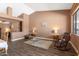 Inviting living room with wood floors, a rocking chair, and views into the dining room at 4020 W Menadota Dr, Glendale, AZ 85308