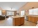 Open-concept living room features a kitchen island, and a cozy couch with a large window providing ample natural light at 4020 W Menadota Dr, Glendale, AZ 85308