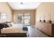 Relaxing main bedroom with a sliding glass door that leads to a backyard pool, combining comfort and outdoor access at 4020 W Menadota Dr, Glendale, AZ 85308