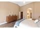 Comfortable main bedroom offering a ceiling fan and easy access to the en-suite bathroom at 4020 W Menadota Dr, Glendale, AZ 85308