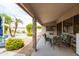 Inviting covered patio with stone pillar, table, and view of the landscaped pool at 4020 W Menadota Dr, Glendale, AZ 85308