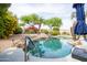 Sparkling pool with a waterfall feature and lush landscaping at 4020 W Menadota Dr, Glendale, AZ 85308