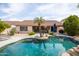 Inviting pool surrounded by patio and desert landscaping at 4020 W Menadota Dr, Glendale, AZ 85308