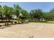 An outdoor basketball court surrounded by mature trees and landscaping for recreational activities at 4123 S Wayne Pl, Chandler, AZ 85249