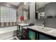Modern bathroom with a dual sink vanity, glass block window, and a bathtub for a spa-like experience at 4123 S Wayne Pl, Chandler, AZ 85249