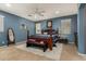 Bedroom with blue walls features carpet, a ceiling fan, natural lighting, and a king bed at 4123 S Wayne Pl, Chandler, AZ 85249