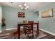 Elegant dining room featuring modern lighting fixture, seating for four, and wood-look flooring at 4123 S Wayne Pl, Chandler, AZ 85249