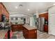 Open kitchen features dark cabinets, kitchen island, gas range, stainless steel appliances, and wood-look flooring at 4123 S Wayne Pl, Chandler, AZ 85249