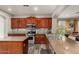 Spacious kitchen with dark wood cabinetry, center island, granite counters and tiled backsplash at 4123 S Wayne Pl, Chandler, AZ 85249