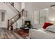 The living room features a staircase, a large window, a sofa, and a black coffee table at 4123 S Wayne Pl, Chandler, AZ 85249