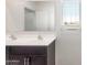 Bathroom featuring a double sink vanity, framed mirror, and a window allowing for natural light at 42915 W Palo Amarillo Rd, Maricopa, AZ 85138