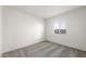 Minimalist bedroom with carpeted floors, white walls and a window allowing natural light to fill the space at 42915 W Palo Amarillo Rd, Maricopa, AZ 85138
