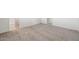 Spacious bedroom with neutral carpet, white walls, and a door leading to the bathroom at 42915 W Palo Amarillo Rd, Maricopa, AZ 85138