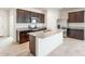 Spacious kitchen featuring granite countertops, dark cabinets, stainless steel appliances, and a kitchen island at 42915 W Palo Amarillo Rd, Maricopa, AZ 85138