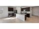 Bright, spacious kitchen featuring an island, stainless appliances, and dark cabinetry at 42930 W Palo Amarillo Rd, Maricopa, AZ 85138