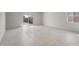 Bright and airy living room with tile flooring and sliding glass doors to the backyard at 42930 W Palo Amarillo Rd, Maricopa, AZ 85138