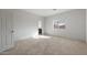 Bedroom with neutral carpet, white walls, window and ensuite entrance at 42945 W Palo Amarillo Rd, Maricopa, AZ 85138